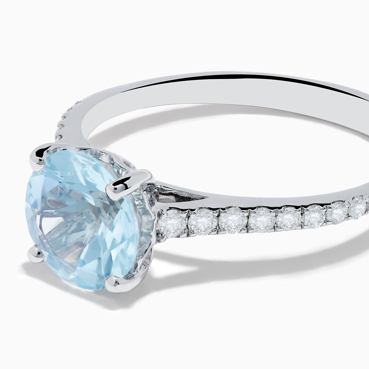 The Aquarius 14K White Gold Aquamarine and Diamond Ring showcases a large oval aquamarine centerpiece with sparkling diamonds along the band, elegantly displayed on a plain white background.