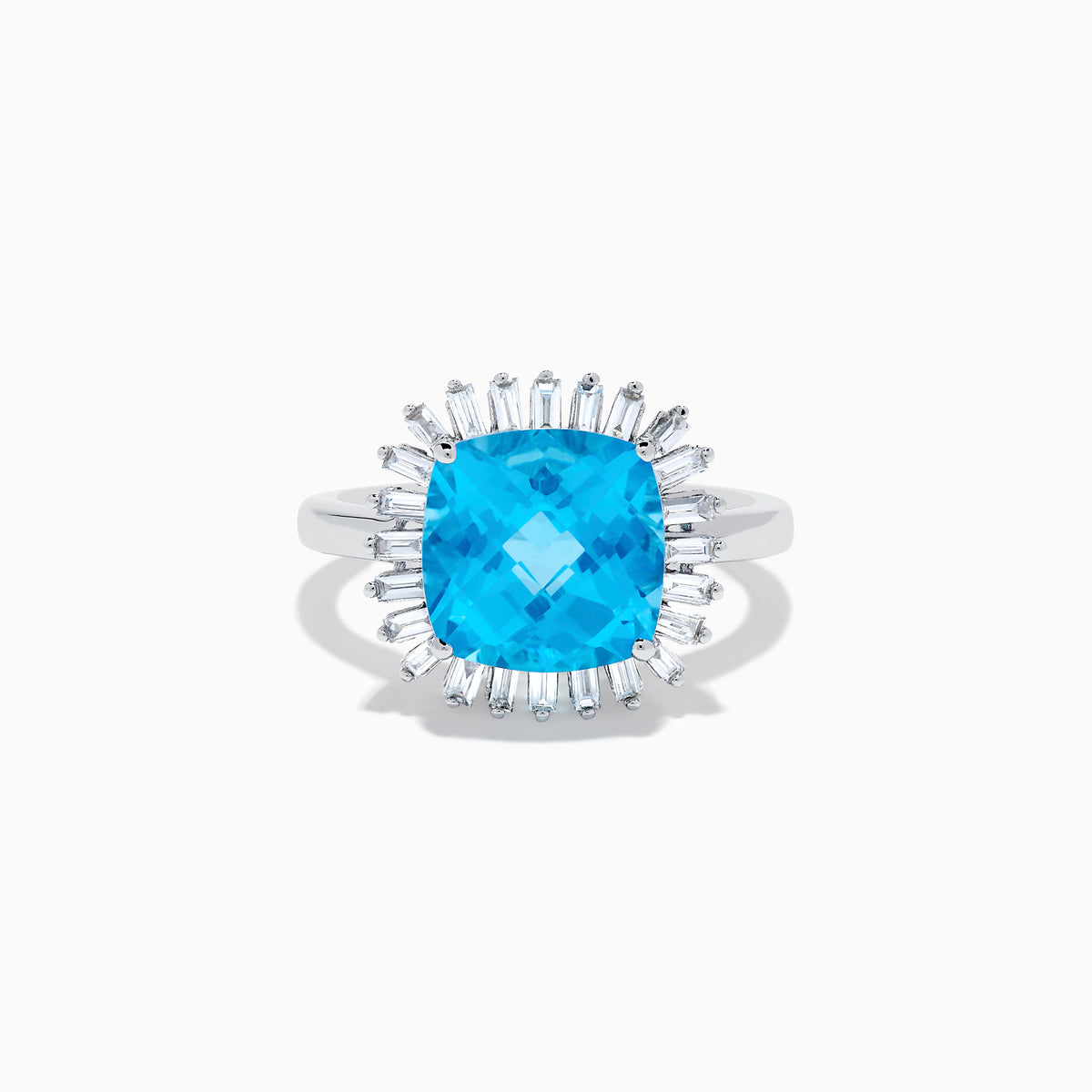 The Ocean Bleu 14K White Gold Blue Topaz and Diamond Halo Ring features a large cushion-cut blue topaz center stone, surrounded by a sparkling halo of baguette-shaped diamonds, all set in elegant white gold.