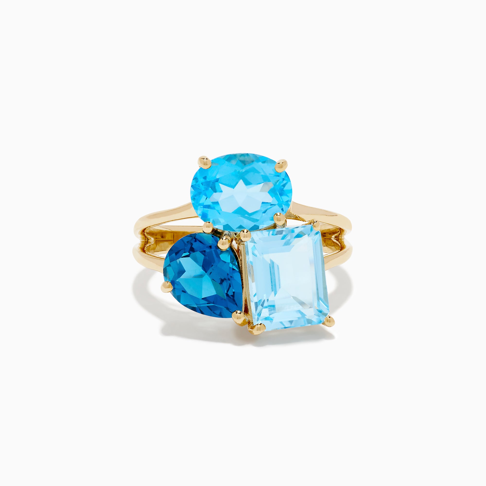 The 14K Yellow Gold London, Swiss & Sky Blue Cocktail Ring features three asymmetrically-clustered gemstones: an oval light blue, a round Swiss blue, and a rectangular light blue stone.