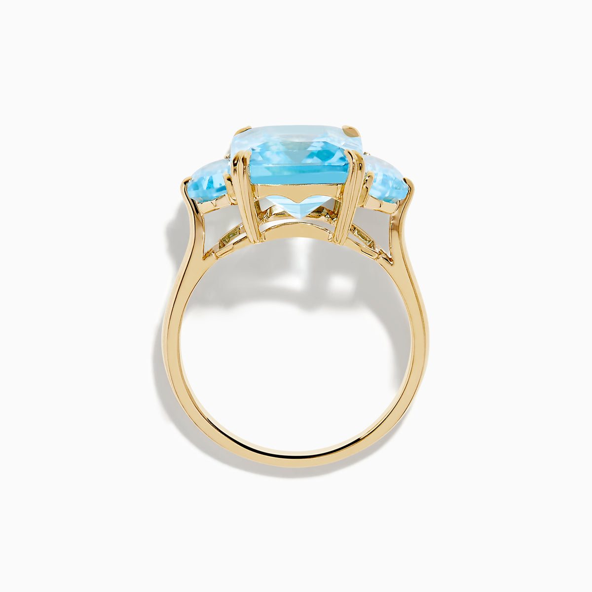 The Ocean Bleu 14K Yellow Gold Sky Blue Topaz 3-Stone Ring showcases a large rectangular blue topaz center stone with two smaller rectangular stones on each side, set against a white background.