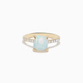 The Aurora 14K Yellow Gold Opal and Diamond Ring features a rectangular opal center accented by small round diamonds along the band, shown against a white background.