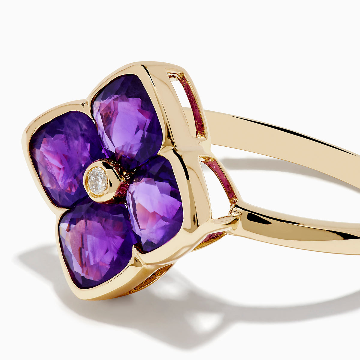 The 14K Yellow Gold Amethyst and Diamond Ring showcases a flower motif with four amethyst petals and a central round diamond, set against a white background.