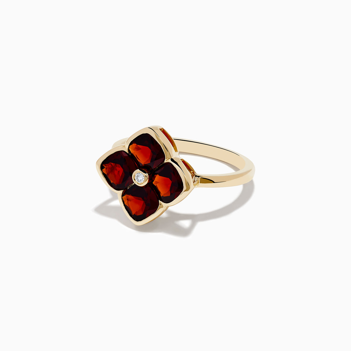 A 14K yellow gold ring featuring a red clover-shaped design in garnet with four gold-outlined petals and a small round diamond at the center.