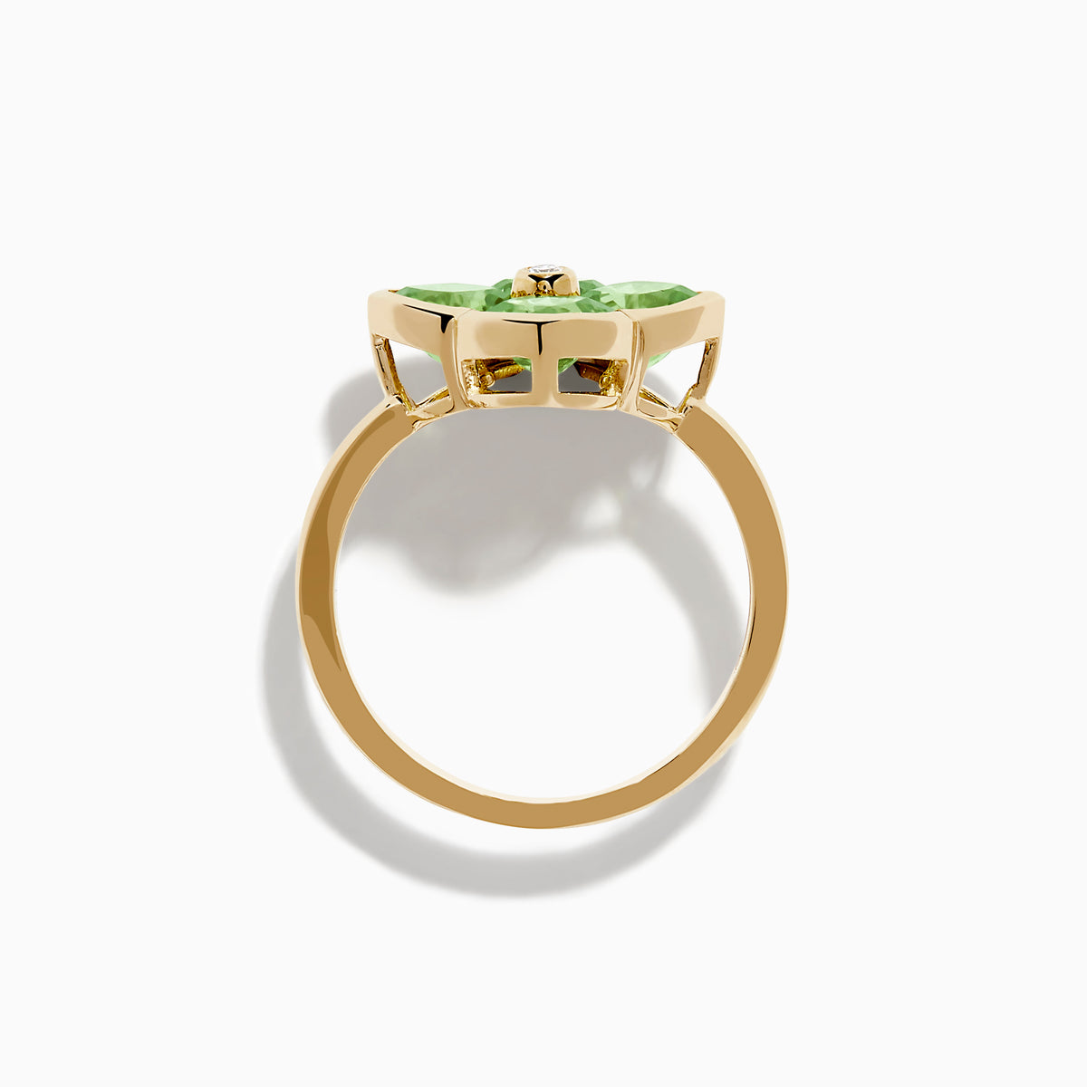 The 14K Yellow Gold Peridot and Diamond Ring displays a clover-shaped design with four faceted green peridots and a central round diamond, shown against a white background.