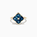 The Ocean Bleu 14K Yellow Gold London Blue Topaz and Diamond Ring showcases a clover design with four London Blue Topaz stones and a central round diamond, set against a white background.
