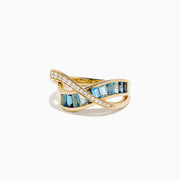 The Ocean Blue 14K Yellow Gold Blue Topaz and Diamond Criss Cross Ring features an infinity design: one band set with white diamonds, the other with rectangular blue topaz gemstones, shown on a white background.