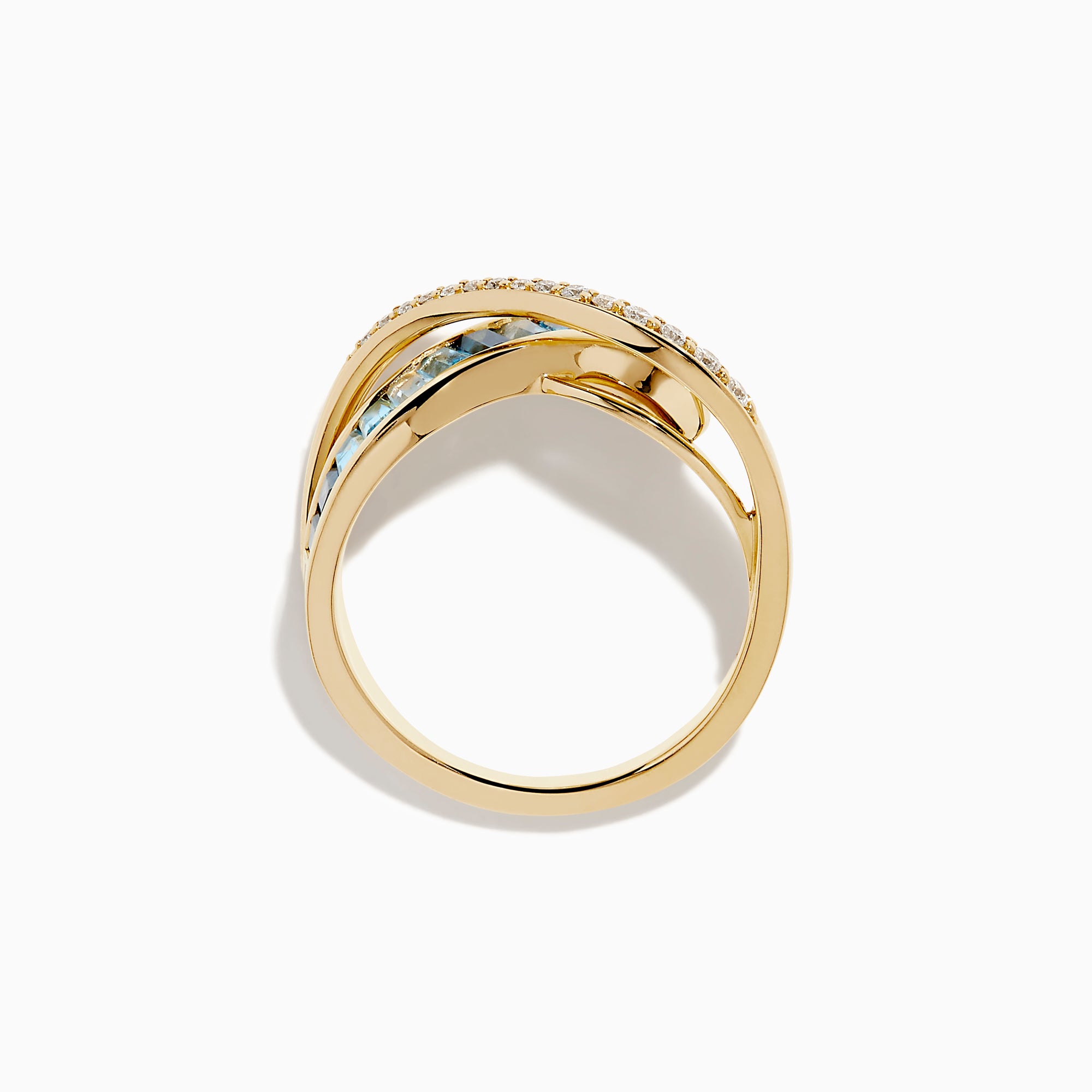 The Ocean Blue 14K Yellow Gold Blue Topaz and Diamond Criss Cross Ring features an infinity design: one band set with white diamonds, the other with rectangular blue topaz gemstones, shown on a white background.