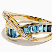 The Ocean Blue 14K Yellow Gold Blue Topaz and Diamond Criss Cross Ring features an infinity design: one band set with white diamonds, the other with rectangular blue topaz gemstones, shown on a white background.