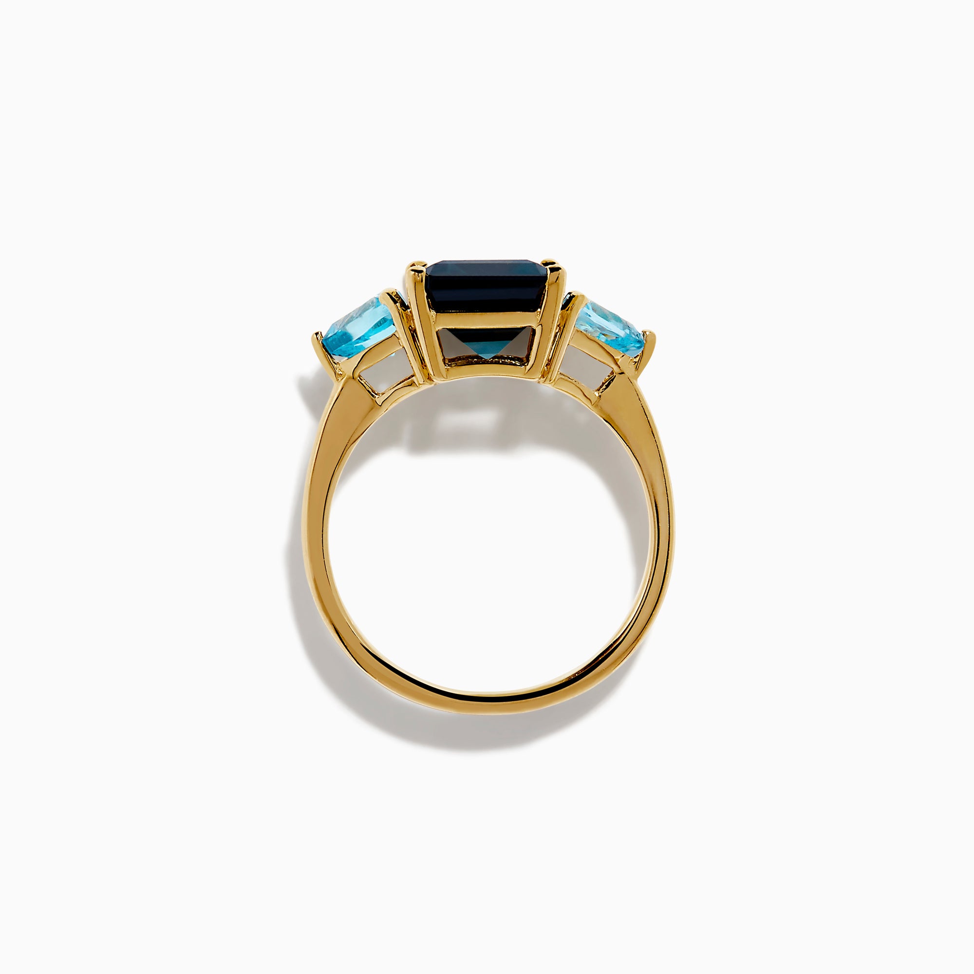 The 14K Yellow Gold Sky Blue and London Blue Topaz 3 Stone Ring features a large rectangular blue topaz flanked by two heart-shaped stones, all set in yellow gold. A stunning piece for any occasion.