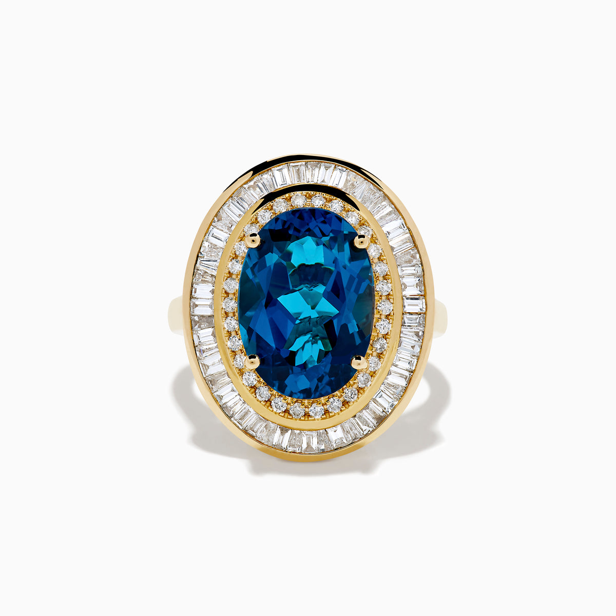 The 14K Yellow Gold London Blue Topaz and Diamond Double Halo Ring features an oval London Blue Topaz at the center, encircled by two halos of sparkling round and baguette-cut diamonds.