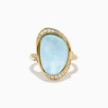 A 14K yellow gold ring featuring a sky blue topaz and mother of pearl doublet, accented with small round diamonds and set against a white background.