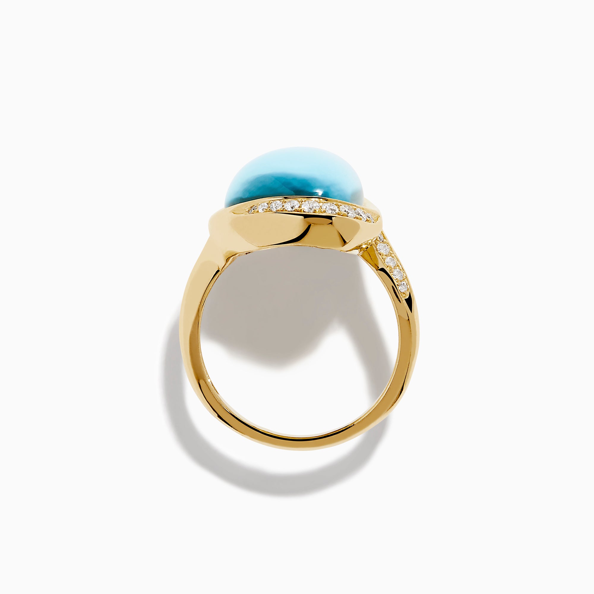 A 14K yellow gold ring featuring a sky blue topaz and mother of pearl doublet, accented with small round diamonds and set against a white background.