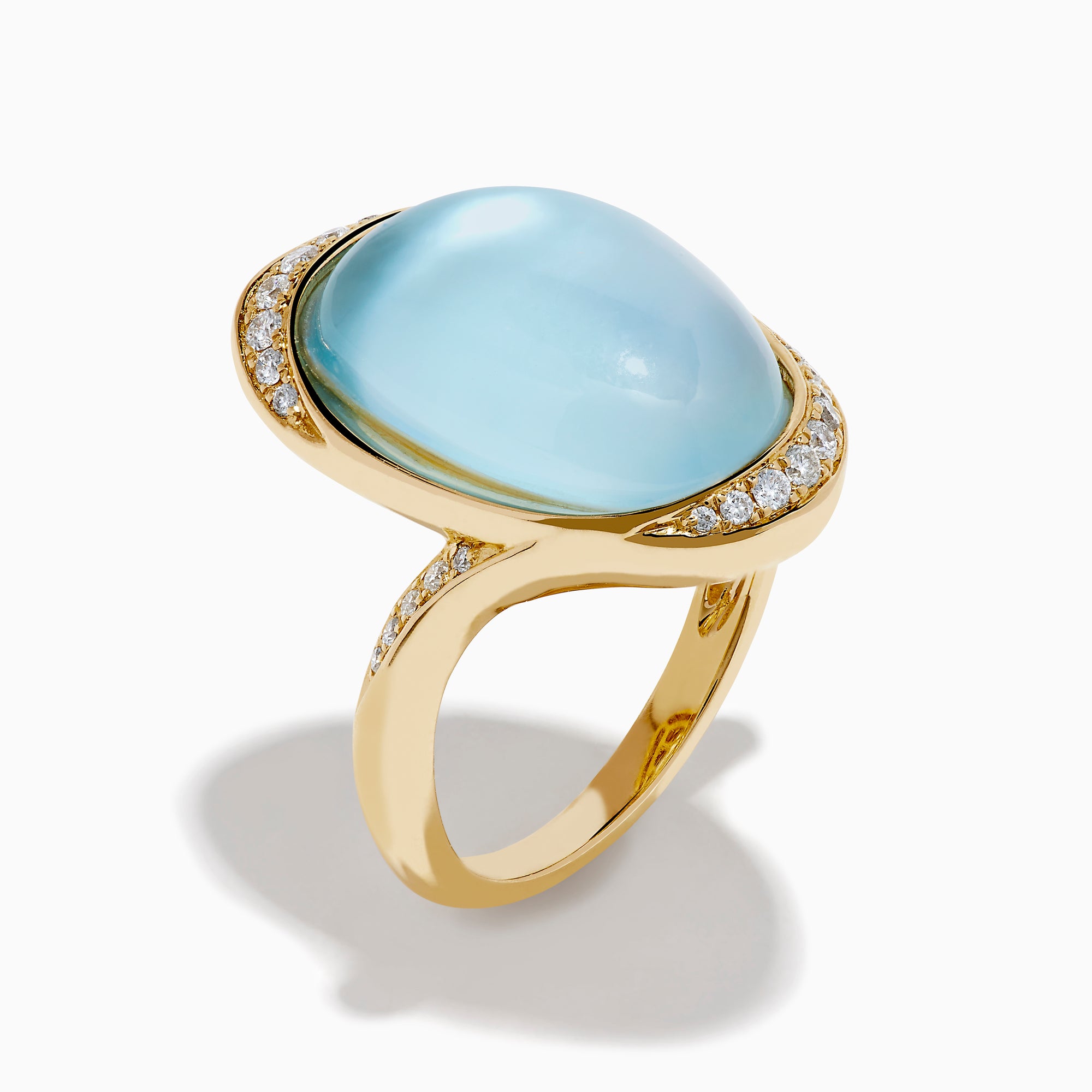 A 14K yellow gold ring featuring a sky blue topaz and mother of pearl doublet, accented with small round diamonds and set against a white background.