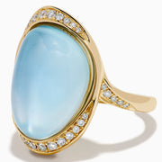 A 14K yellow gold ring featuring a sky blue topaz and mother of pearl doublet, accented with small round diamonds and set against a white background.