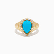 The 14K Yellow Gold Turquoise and Diamond Pear Halo Dome Ring features a teardrop-shaped turquoise center stone, encircled by a sparkling halo of small diamonds in a pear-shaped design, displayed on a white background.