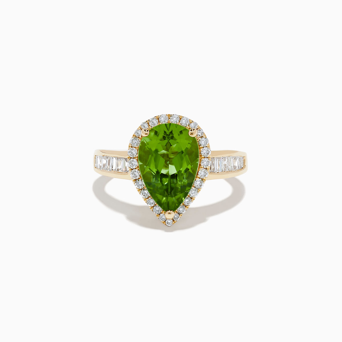 The 14K Yellow Gold Pear Shaped Peridot and Diamond Cocktail Ring features a pear-cut peridot center, a halo of white diamonds, and baguette-cut diamonds along the band for a dazzling, elegant look.