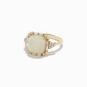 The Aurora 14K Yellow Gold Opal and Diamond Ring features a rectangular opal center stone with a decorative halo of round and baguette-cut diamonds, beautifully set in yellow gold.