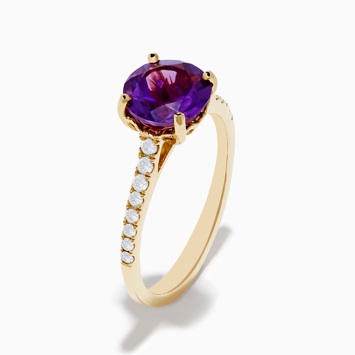 The 14K Yellow Gold Amethyst and Diamond Ring showcases a large round amethyst center accented with small white diamonds along the band, displayed on a white background.
