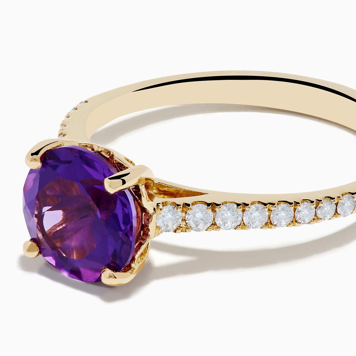 The 14K Yellow Gold Amethyst and Diamond Ring showcases a large round amethyst center accented with small white diamonds along the band, displayed on a white background.