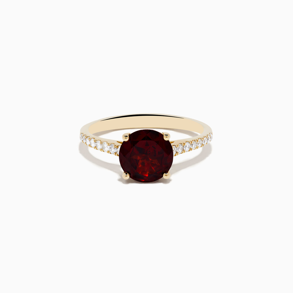 The 14K Yellow Gold Garnet and Diamond Ring features a large round deep red garnet center, accented by small white diamonds on each side of the band, displayed against a white background.