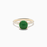 The 14K Yellow Gold Dyed Jade Ring Diamond Ring features a large round dyed jade center stone with small white diamonds set along the band.
