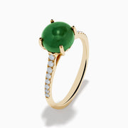 The 14K Yellow Gold Dyed Jade Ring Diamond Ring features a large round dyed jade center stone with small white diamonds set along the band.