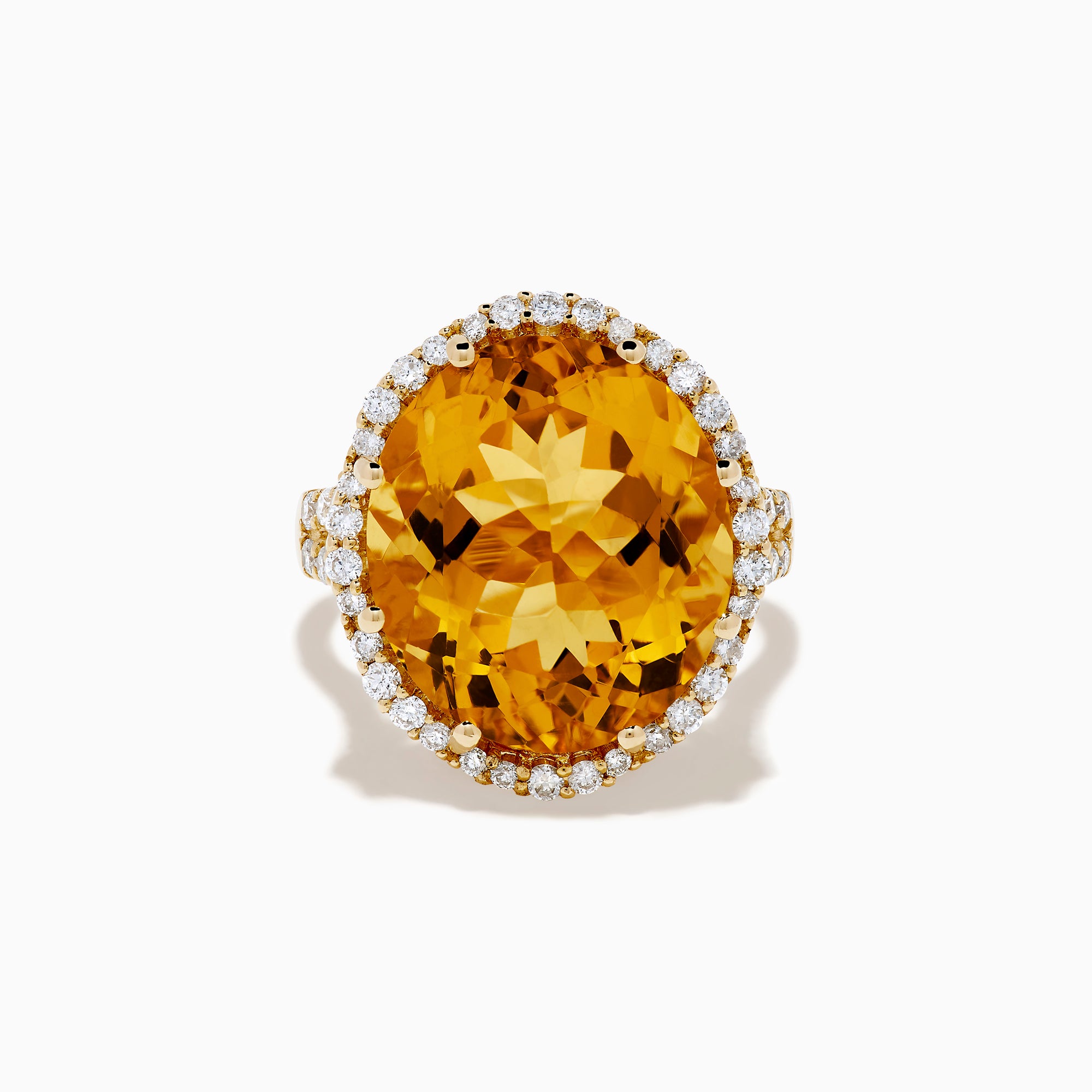 The Sunset 14K Yellow Gold Citrine and Diamond Halo Ring features a large oval citrine surrounded by sparkling diamonds, beautifully set against a plain white background.
