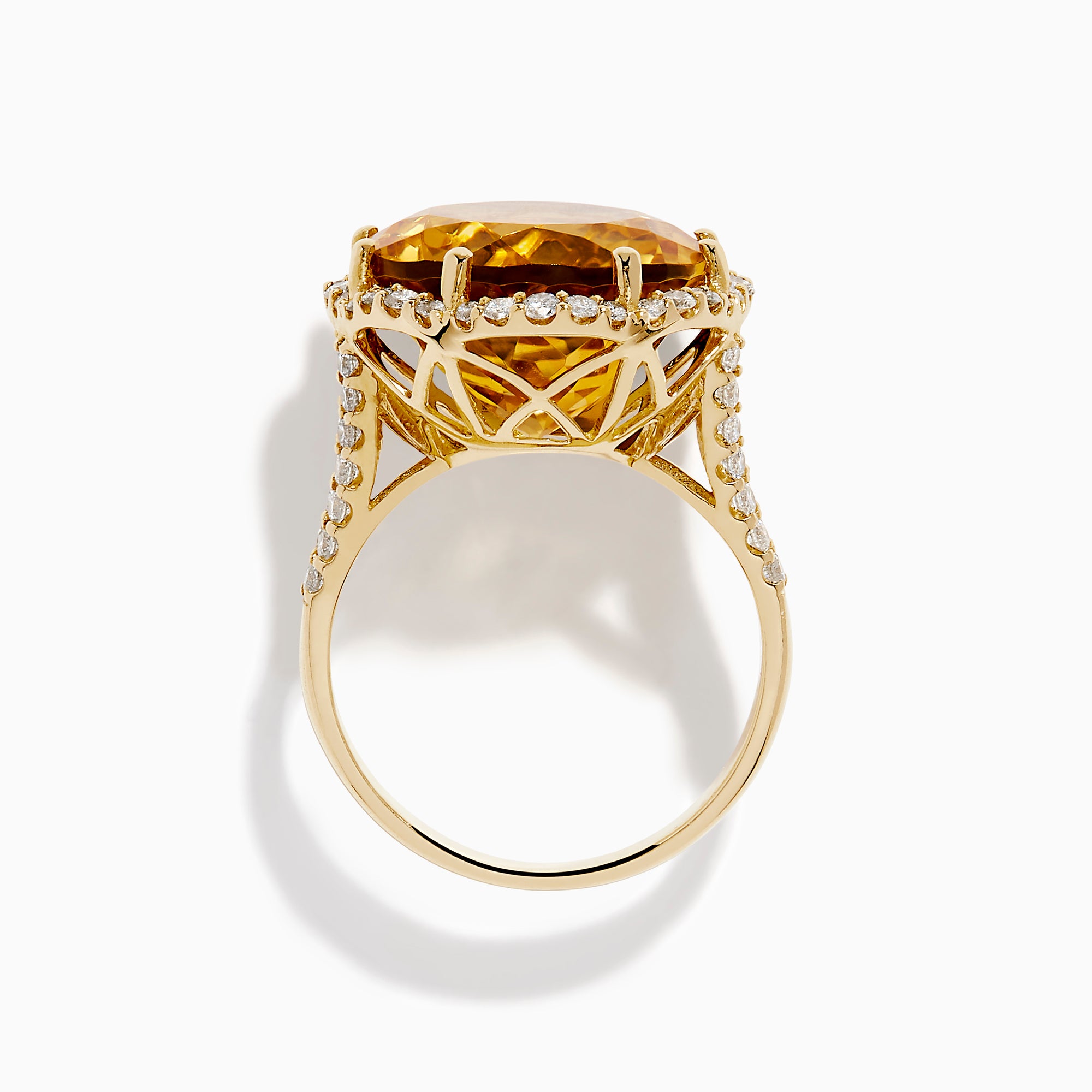 The Sunset 14K Yellow Gold Citrine and Diamond Halo Ring features a large oval citrine surrounded by sparkling diamonds, beautifully set against a plain white background.