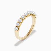 The 14K Yellow Gold Cultured Fresh Water Pearl Band features a row of small, round cultured freshwater pearls set along the top and is shown on a white background.