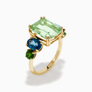 The 14K Yellow Gold Amethyst, Blue Topaz, and Chrome Diopside Cocktail Ring features a large rectangular amethyst center stone, flanked by two oval blue topaz and two smaller chrome diopside stones on each side.