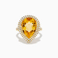 The 14K Yellow Gold Citrine and Diamond Pear Halo Cocktail Ring features a large pear-shaped citrine surrounded by a halo of round diamonds, shown on a white background.