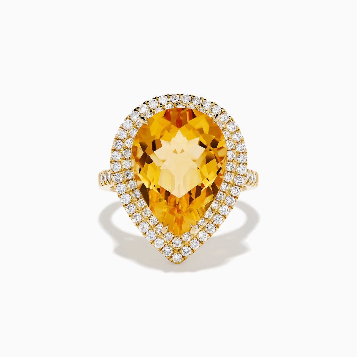 The 14K Yellow Gold Citrine and Diamond Pear Halo Cocktail Ring features a large pear-shaped citrine surrounded by a halo of round diamonds, shown on a white background.