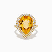 The 14K Yellow Gold Citrine and Diamond Pear Halo Cocktail Ring features a large pear-shaped citrine surrounded by a halo of round diamonds, shown on a white background.