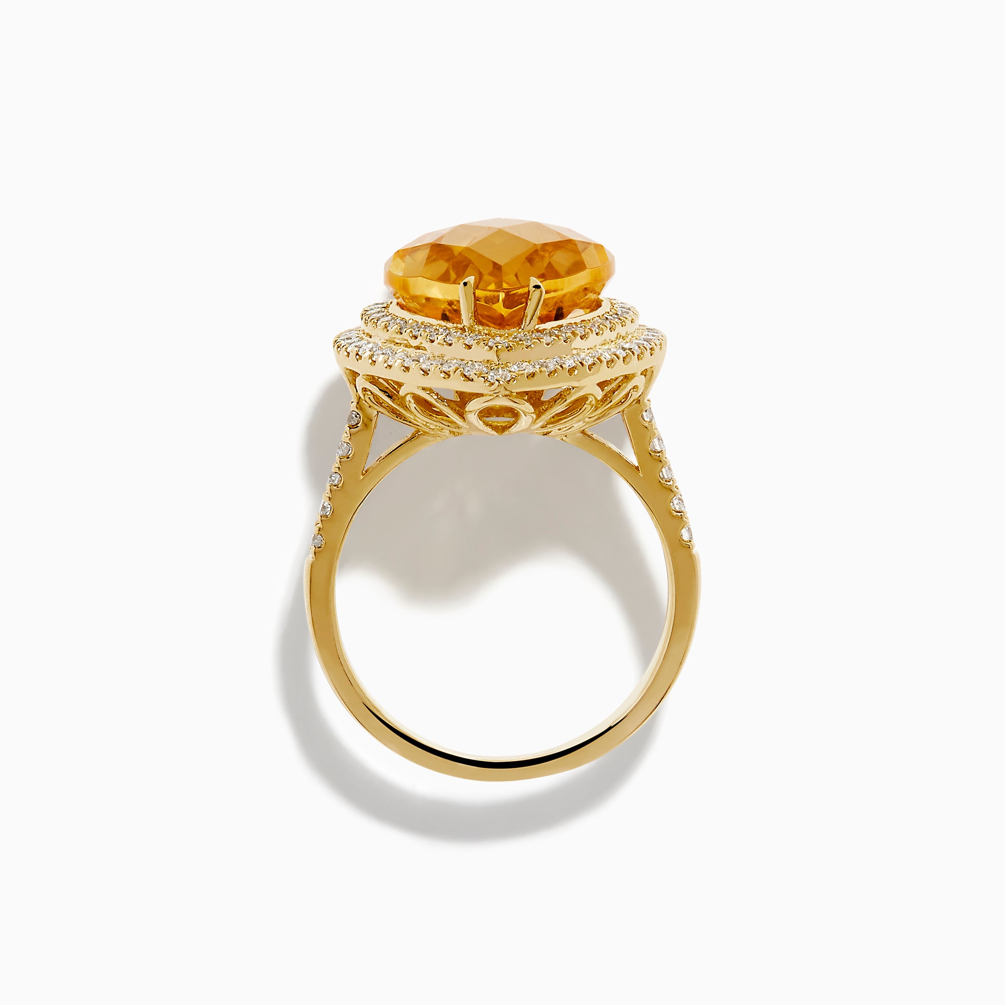 The 14K Yellow Gold Citrine and Diamond Pear Halo Cocktail Ring features a large pear-shaped citrine surrounded by a halo of round diamonds, shown on a white background.