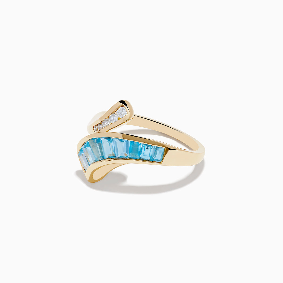 The Ocean Bleu 14K Yellow Gold Blue Topaz and Diamond Bypass Ring features sparkling white diamonds on one side and a row of rectangular blue topaz stones on the other in an elegant bypass design.