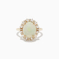 The Aurora 14K Yellow Gold Opal Diamond Ring showcases an oval opal center, encircled by a halo of baguette-cut diamonds, set against a white background.