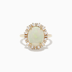 The Aurora 14K Yellow Gold Opal Diamond Ring showcases an oval opal center, encircled by a halo of baguette-cut diamonds, set against a white background.