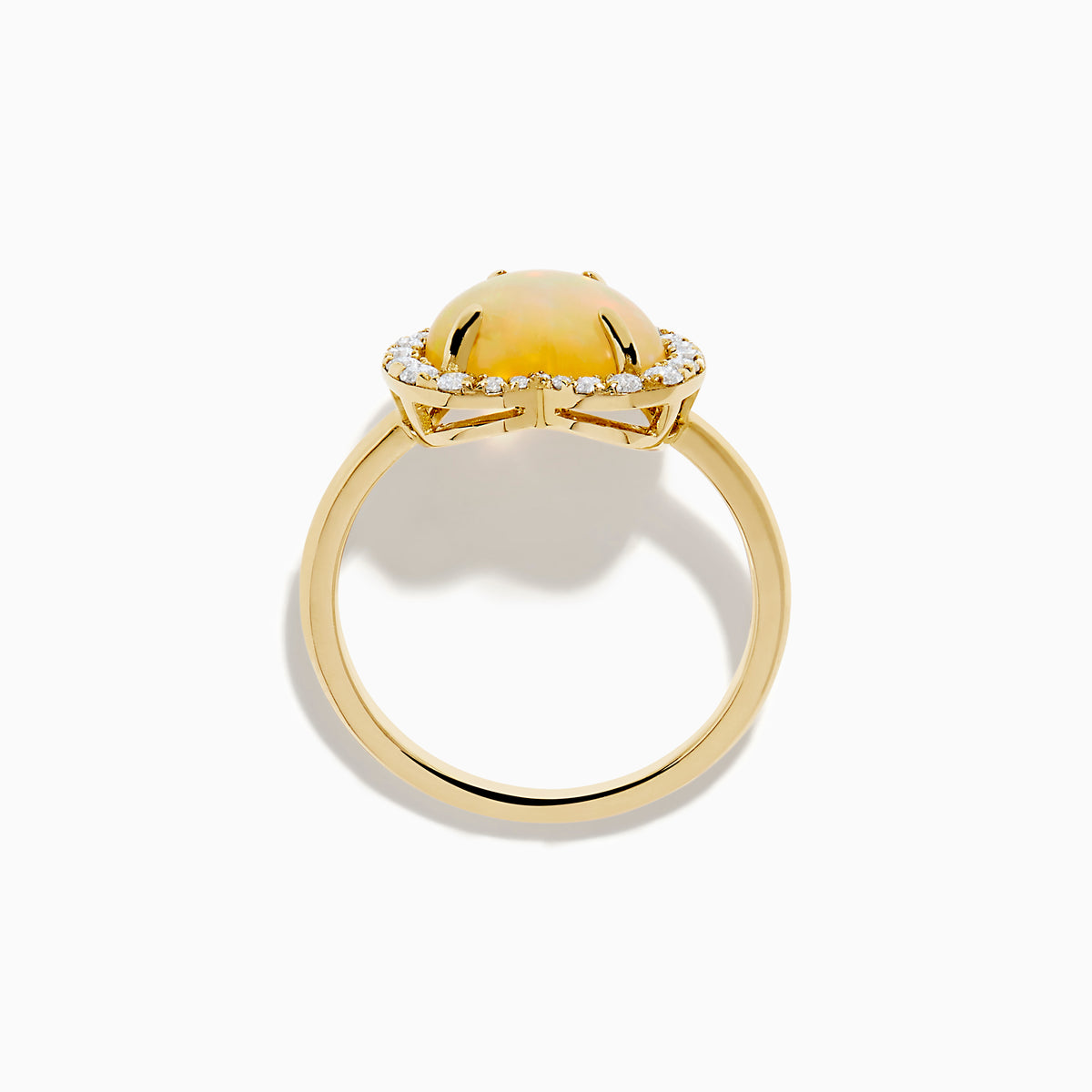 The Aurora 14K Yellow Gold Opal and Diamond Heart Halo Ring features a heart-shaped opal at the center, surrounded by a diamond halo.