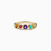 The 14K Yellow Gold Multi Color Gemstone Bezel Band features a row of bezel-set purple, red, turquoise, orange, and green gemstones in various shapes and sizes.