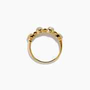 The 14K Yellow Gold Opal and Diamond Bezel Band showcases four round opals and three small rectangular diamonds set in a row, displayed on a white background.