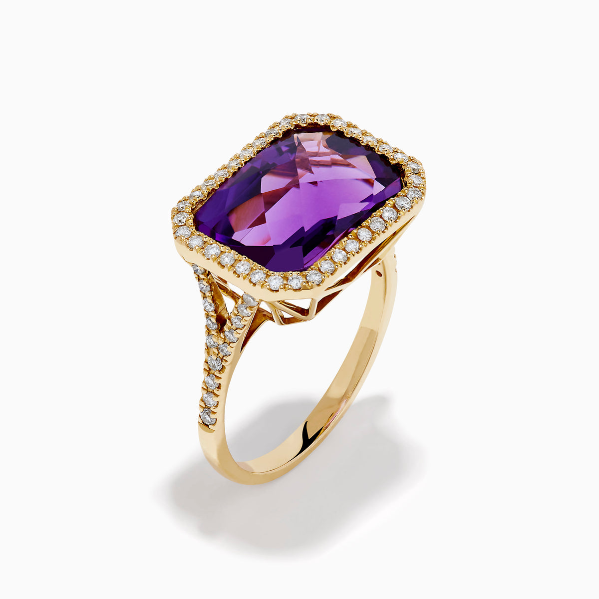 The 14K Yellow Gold Amethyst and Diamond Halo East West Cocktail Ring showcases a rectangular purple amethyst center with a diamond halo, set on yellow gold, displayed on a plain white background.