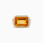 The 14K Yellow Gold Citrine and Diamond Halo East West Cocktail Ring showcases a large rectangular citrine gemstone with a diamond halo on a simple gold band, photographed against a white background.