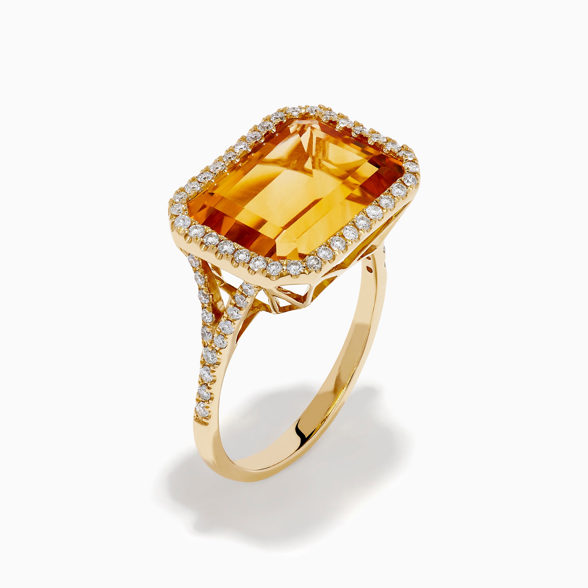 The 14K Yellow Gold Citrine and Diamond Halo East West Cocktail Ring showcases a large rectangular citrine gemstone with a diamond halo on a simple gold band, photographed against a white background.