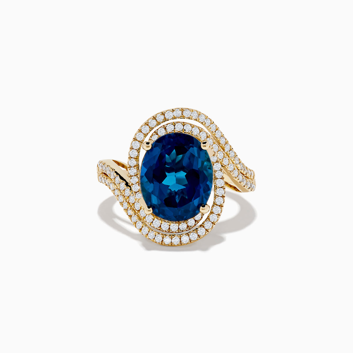 The Ocean Blue 14K Gold London Blue Topaz and Diamond Ring showcases a large oval topaz centerpiece, accented by two wavy rows of sparkling diamonds.
