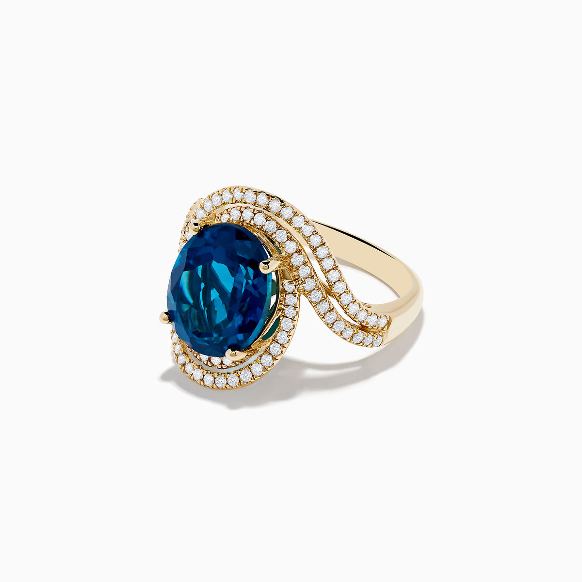 The Ocean Blue 14K Gold London Blue Topaz and Diamond Ring showcases a large oval topaz centerpiece, accented by two wavy rows of sparkling diamonds.