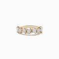 The Aurora 14K Yellow Gold Opal and Diamond Ring features seven oval opals in a row, each separated by sparkling round diamonds, shown on a white background.