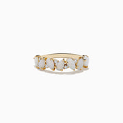The Aurora 14K Yellow Gold Opal and Diamond Ring features seven oval opals in a row, each separated by sparkling round diamonds, shown on a white background.