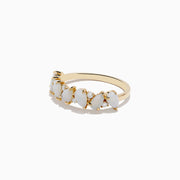 The Aurora 14K Yellow Gold Opal and Diamond Ring features seven oval opals in a row, each separated by sparkling round diamonds, shown on a white background.