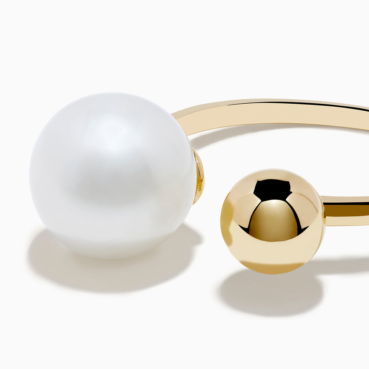 The 14K Yellow Gold Fresh Water Pearl and Bead Open Ring features a gleaming pearl on one end and a polished gold bead on the other, all showcased against a white background.