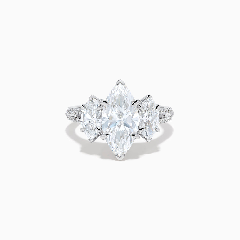 The Lab Grown Marquise Diamond 3 Stone Ring in 14K White Gold features a central marquise-cut lab grown diamond, two flanking marquise-cut diamonds, and two round diamonds set on a detailed band against a white background.